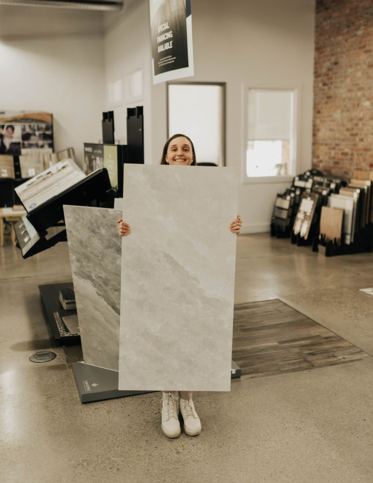 tillsonburg flooring canada team member holding large tile sample